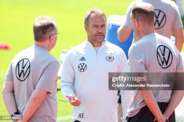Head coach Hans-Dieter Flick talks to his team doctors Prof. Dr. Tim Meyer and Dr. Jochen Hahne during a training session of the German national...