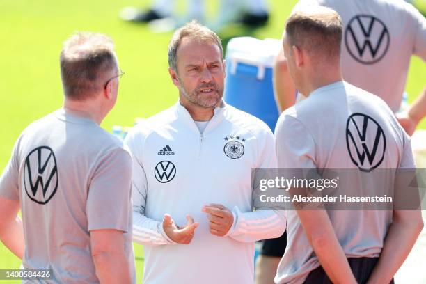 Head coach Hans-Dieter Flick talks to his team doctors Prof. Dr. Tim Meyer and Dr. Jochen Hahne during a training session of the German national...