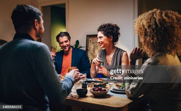 multi-ethnic friends having fun together - dinner with friends stockfoto's en -beelden