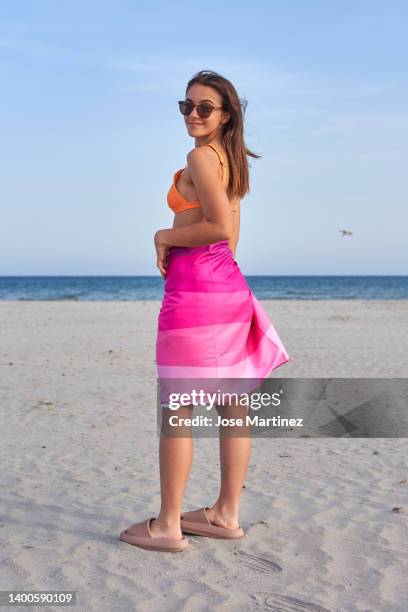 portrait of a girl on the beach enjoying her summer vacation - toalla stock pictures, royalty-free photos & images