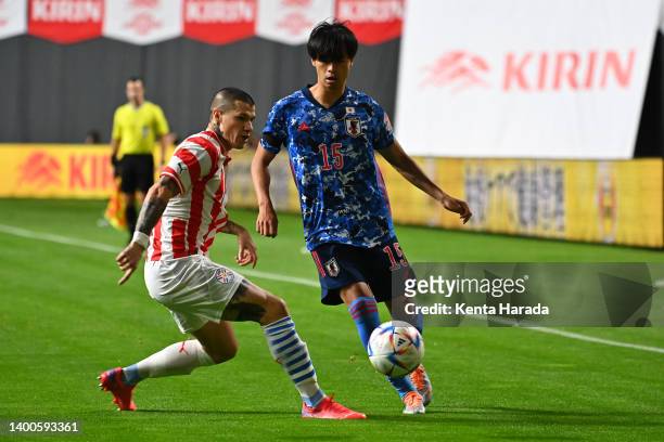 Kaoru Mitoma of Japan controls the ball under pressure of Alan Benitez of Paraguay during the international friendly match between Japan and Paraguay...