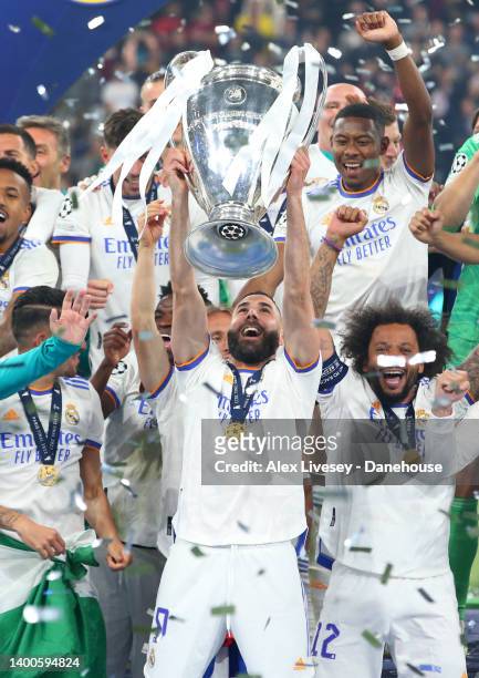 Karim Benzema of Real Madrid lifts the UEFA Champions League trophy alongside his team mates after winning the UEFA Champions League final match...