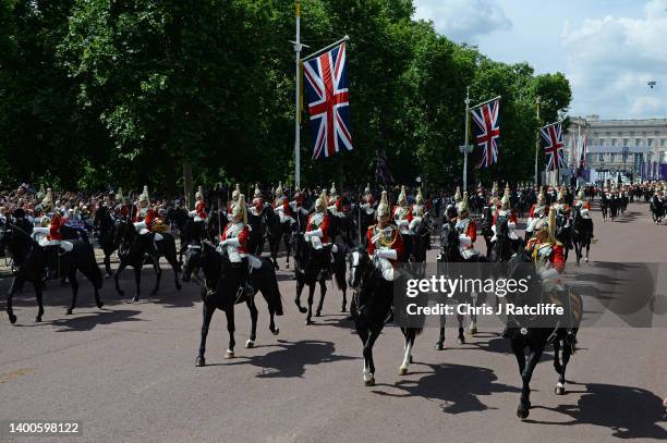 The Household Cavalry ride down The Mall during the Trooping the Colour parade at Buckingham Palace on June 02, 2022 in London, England. The Platinum...