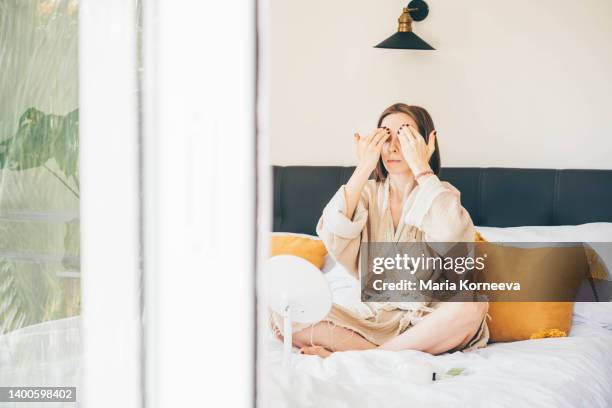 woman doing facial massage at home. - facial massage stock pictures, royalty-free photos & images