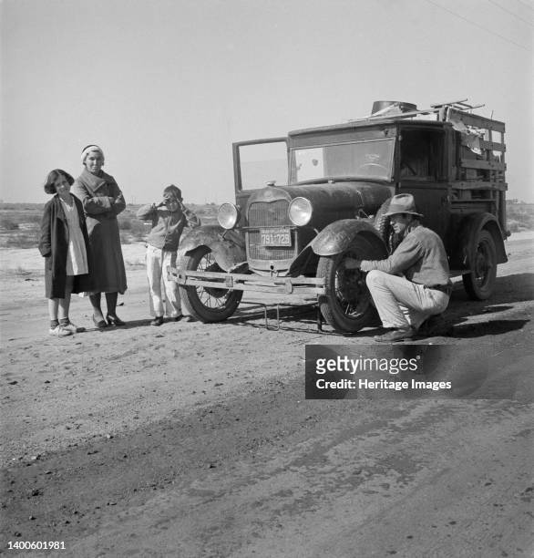 Drought refugee family from McAlester, Oklahoma. Arrived in California October 1936 to join the cotton harvest. Near Tulare, California. Artist...