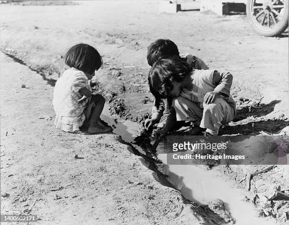 Mexican Children Playing In Ditch