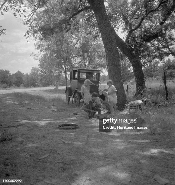 Migrant family from Oklahoma in Texas. A family of six alongside the road. An example of how they fall between the relief agencies. The father, aged...