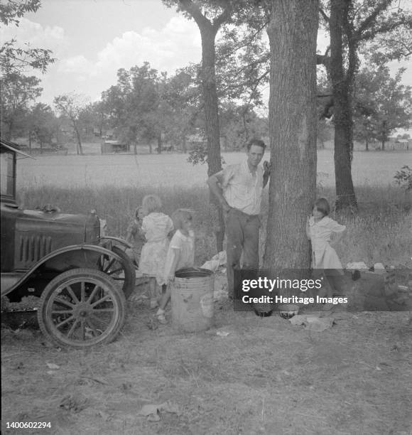 Migrant family from Oklahoma in Texas. A family of six alongside the road. An example of how they fall between the relief agencies. The father, aged...