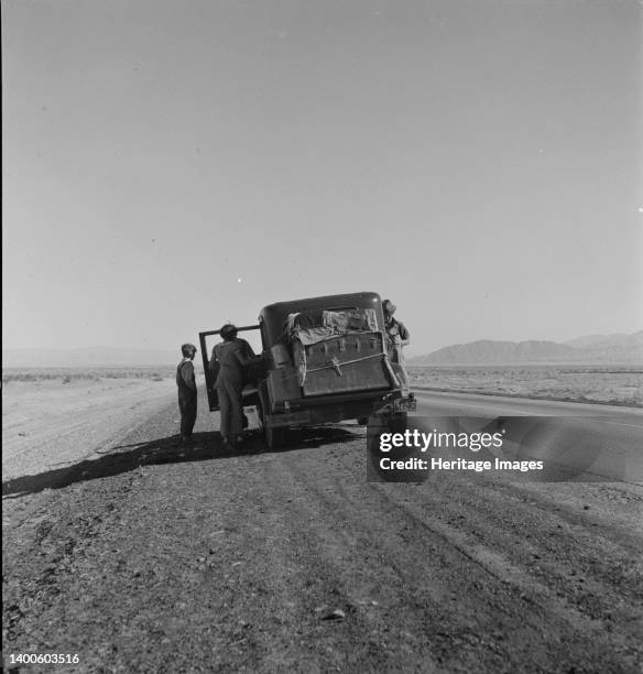 Oklahoma sharecropper entering California stalled on the desert with his wife and four children. Artist Dorothea Lange.