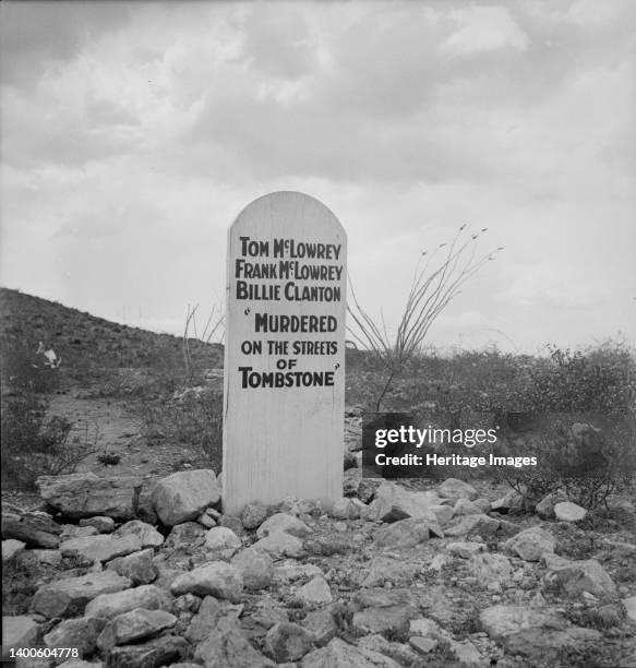 Sign near Tombstone, Arizona. Boot Hill graveyard. ['Tom McLowrey, Frank McLowrey, Billie Clanton: "Murdered on the Streets of Tombstone"']. Artist...