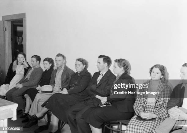 Night meeting in the Farm Security Administration office, Rural Rehabilitation Division, Visalia, Tulare County, California. 144 families have...