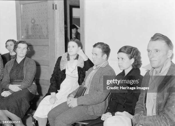 Night meeting in the Farm Security Administration office, Rural Rehabilitation Division, Visalia, Tulare County, California. 144 families have...