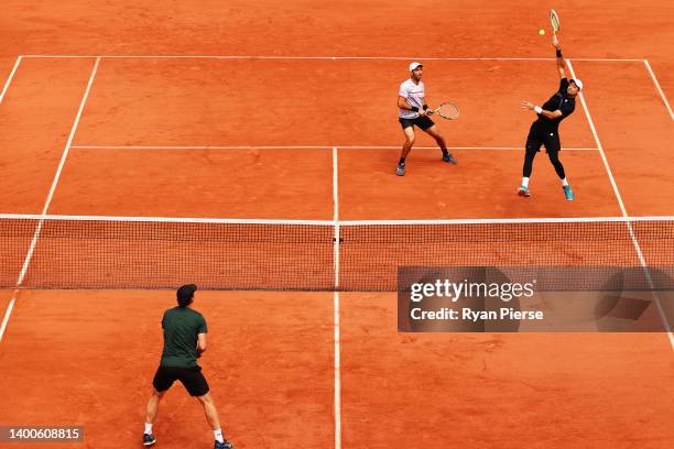 Marcelo Arevalo of El Salvador plays a smash as partner Julien Rojer of France looks on against Matwe Middelkoop of France and Rohan Bopanna of India...