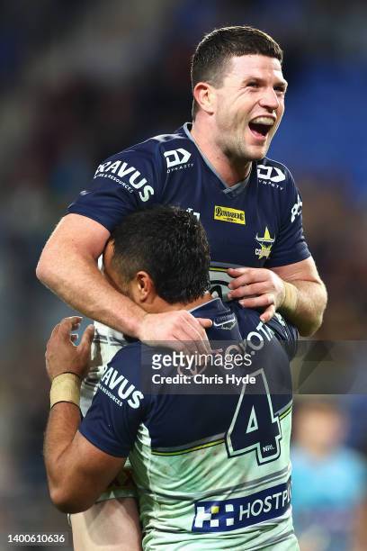 Chad Townsend of the Cowboys celebrates with Peta Hiku of the Cowboys after a try by Hiku during the round 13 NRL match between the Gold Coast Titans...