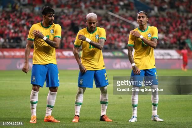 Neymar Jr. Of Brazil celebrates scoring his side's second goal with his teammates Lucas Paqueta and Raphinha during the international friendly match...