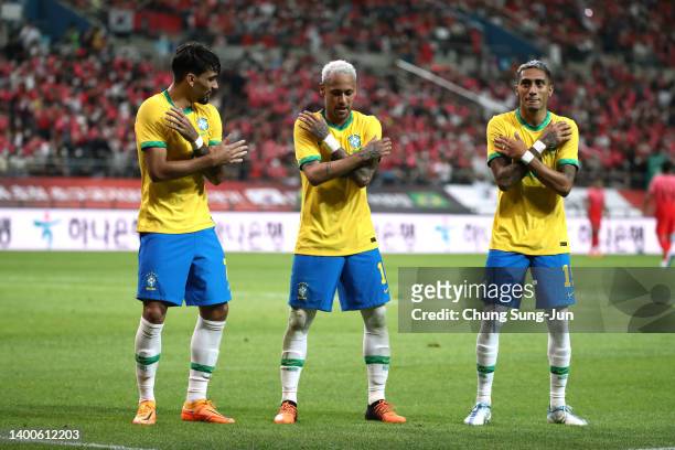 Neymar Jr. Of Brazil celebrates scoring his side's second goal with his teammates Lucas Paqueta and Raphinha during the international friendly match...