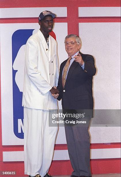 Tim Thomas of the New Jersey Nets shakes hands with NBA Commissioner David Stern during the NBA Draft at the Charlotte Coliseum in Charlotte, North...