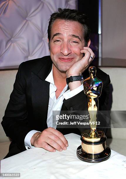 Actor Jean Dujardin poses with his award for Best Actor for 'The Artist,' at the 2012 Vanity Fair Oscar Party Hosted By Graydon Carter at Sunset...