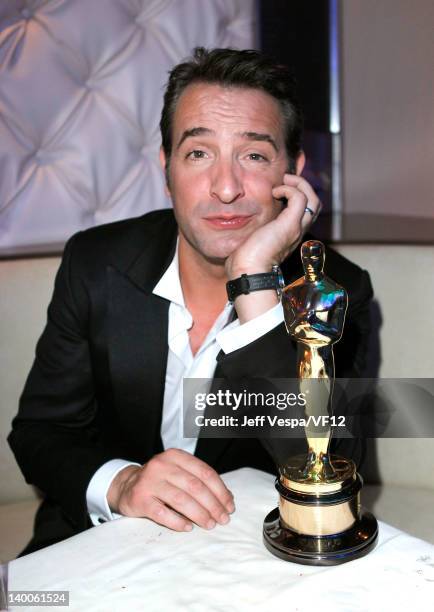 Actor Jean Dujardin poses with his award for Best Actor for 'The Artist,' at the 2012 Vanity Fair Oscar Party Hosted By Graydon Carter at Sunset...