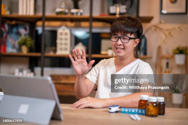 virtual therapist counsels young men during online appointments on laptops at home. - virtual visit stock pictures, royalty-free photos & images