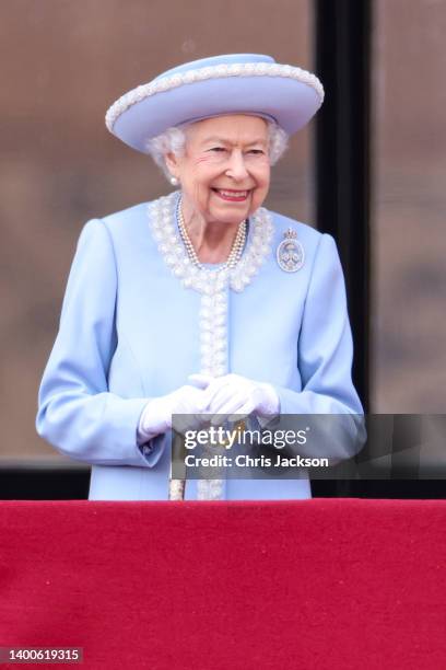 Queen Elizabeth II smiles on the balcony of Buckingham Palace during the Trooping the Colour parade on June 02, 2022 in London, England. The Platinum...