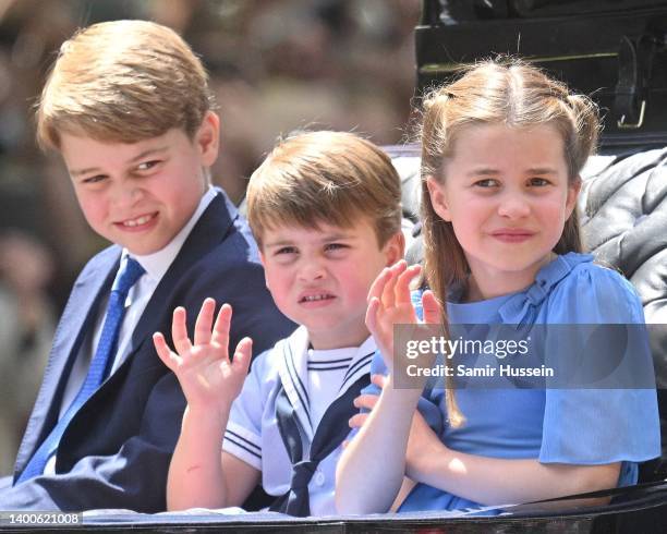 Prince George of Cambridge, Prince Louis of Cambridge and Princess Charlotte of Cambridge ride in a carriage during Trooping The Colour, the Queen's...