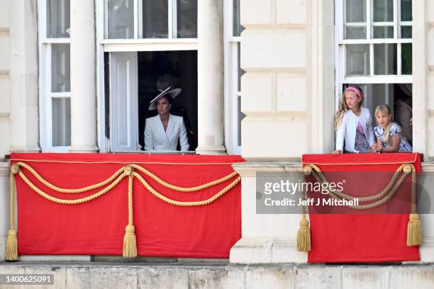 Catherine, Duchess of Cambridge, Savannah Phillips and Isla Phillips during the Trooping the Colour parade at Horse Guards on June 02, 2022 in...