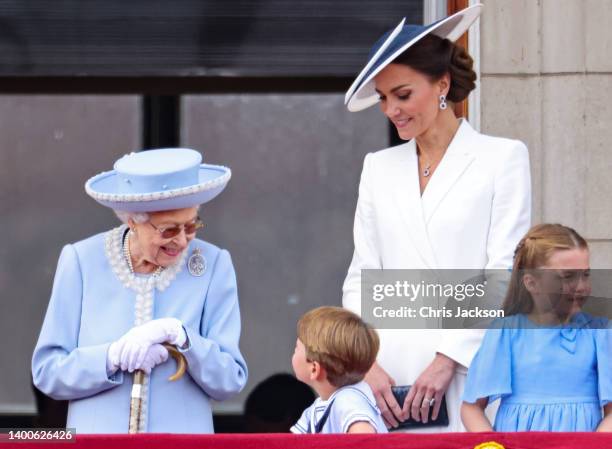 Queen Elizabeth II speaks to Prince Louis of Cambridge as Catherine, Duchess of Cambridge and Princess Charlotte of Cambridge look out on the balcony...