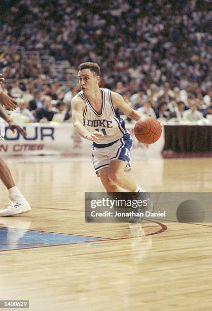 Guard Bobby Hurley of the Duke Blue Devils dribbles the ball down the court during a playoff game against the Michigan Wolverines at the Hubert H....