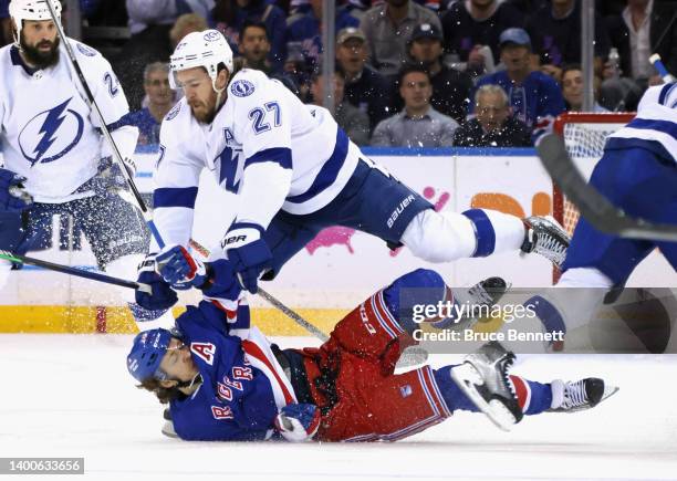 Artemi Panarin of the New York Rangers is checked by Ryan McDonagh of the Tampa Bay Lightning during the first period in Game One of the Eastern...