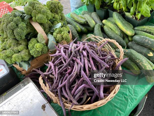 Broccoli, purple string beans and cucumbers from Beagan Youngs Farm at the Deep Roots farmers market in Glen Cove, New York, on July 10, 2021.