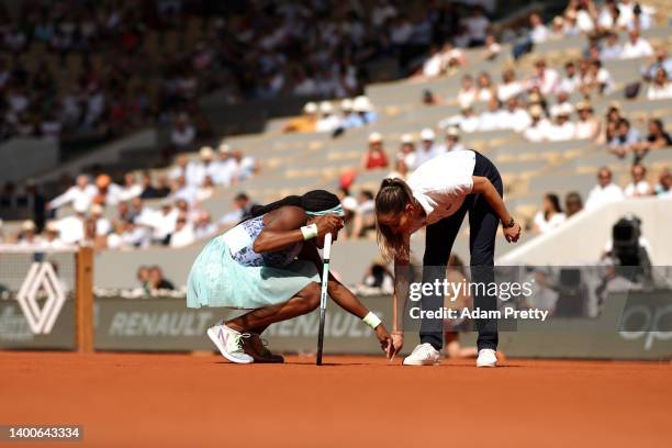 Coco Gauff of United States talks to umpire Marijana Veljovic as they inspect the court against Martina Trevisan of Italy during the Women's Singles...