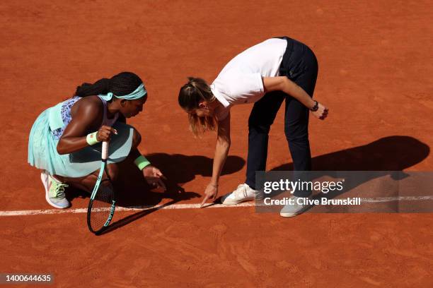 Coco Gauff of United States talks to umpire Marijana Veljovic as they inspect the court against Martina Trevisan of Italy during the Women's Singles...