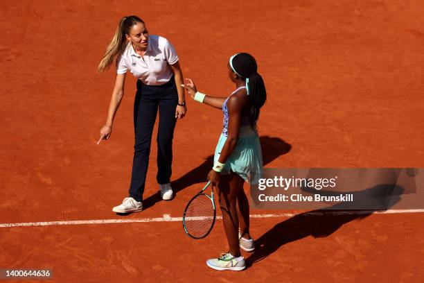 Coco Gauff of United States talks to umpire Marijana Veljovic as they inspect the court against Martina Trevisan of Italy during the Women's Singles...