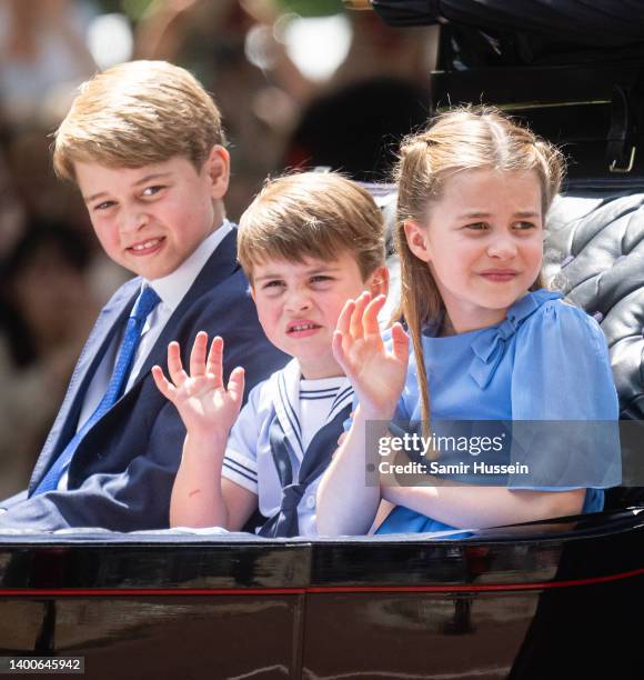 Prince George of Cambridge, Prince Louis of Cambridge and Princess Charlotte of Cambridge ride in a carriage during Trooping The Colour, the Queen's...