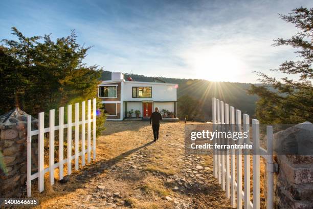 person arriving at sustainable house - simple living stock pictures, royalty-free photos & images