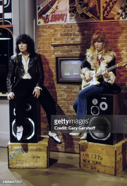View of American siblings & Rock musicians Ann Wilson and Nancy Wilson, both of the group Heart, as they sit on stereo speakers during an interview...