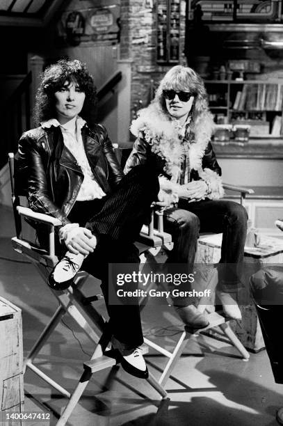 View of American siblings & Rock musicians Ann Wilson and Nancy Wilson, both of the group Heart, seated in director's chairs during an interview on...