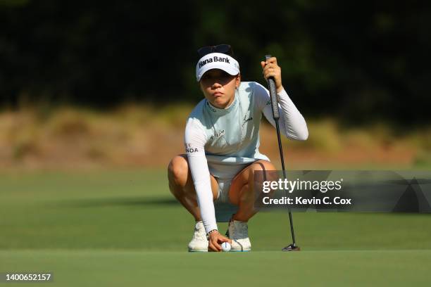 Lydia Ko of New Zealand lines up a putt on the first green during the first round of the 77th US Women's Open Championship at Pine Needles Lodge and...