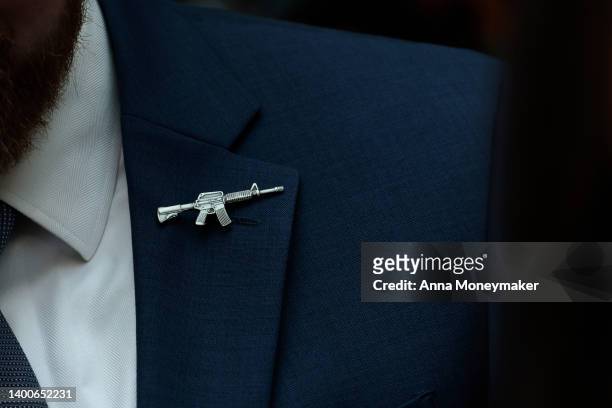 Congressional staffer wears a rifle shaped pin on his suite during a House Judiciary Committee mark up hearing in the Rayburn House Office Building...