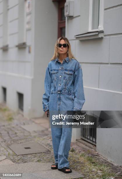 Alessa Winter wearing Chanel black shades, Longchamp black mini bag, The Frankie Shop jeans overall and Inuikii black shoes on May 31, 2022 in...