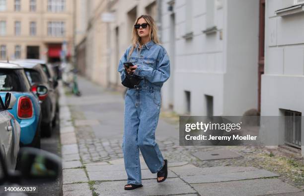 Alessa Winter wearing Chanel black shades, Longchamp black mini bag, The Frankie Shop jeans overall and Inuikii black shoes on May 31, 2022 in...