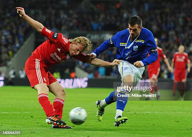 Dirk Kuyt of Liverpool shoots past Andrew Taylor of Cardiff City during the Carling Cup Final match between Liverpool and Cardiff City at Wembley...