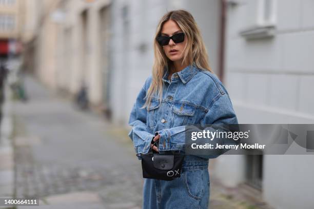 Alessa Winter wearing Chanel black shades, Longchamp black mini bag, The Frankie Shop jeans overall on May 31, 2022 in Berlin, Germany.