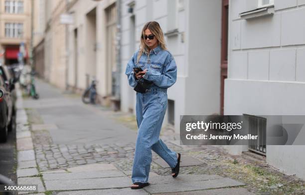 Alessa Winter wearing Chanel black shades, Longchamp black mini bag, The Frankie Shop jeans overall and Inuikii black shoes on May 31, 2022 in...