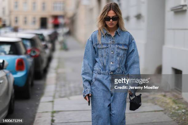 Alessa Winter wearing Chanel black shades, Longchamp black mini bag, The Frankie Shop jeans overall on May 31, 2022 in Berlin, Germany.