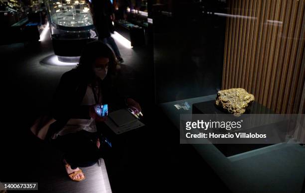 Visitor takes a photo of a 22 kg gold nugget on display at the Royal Treasure Museum in Ajuda National Palace on June 02, 2022 in Lisbon, Portugal....