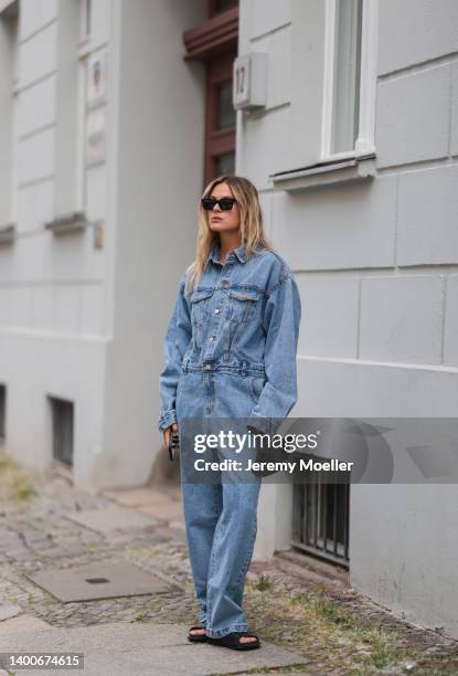 Alessa Winter wearing Chanel black shades, Longchamp black mini bag, The Frankie Shop jeans overall and Inuikii black shoes on May 31, 2022 in...