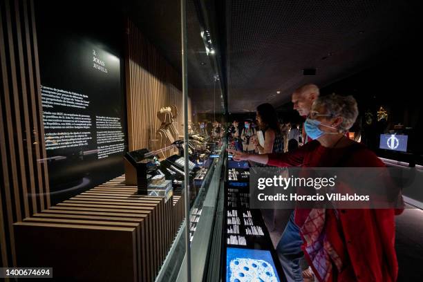 Visitors look at jewels on display at the Royal Treasure Museum in Ajuda National Palace on June 02, 2022 in Lisbon, Portugal. The Museu do Tesouro...