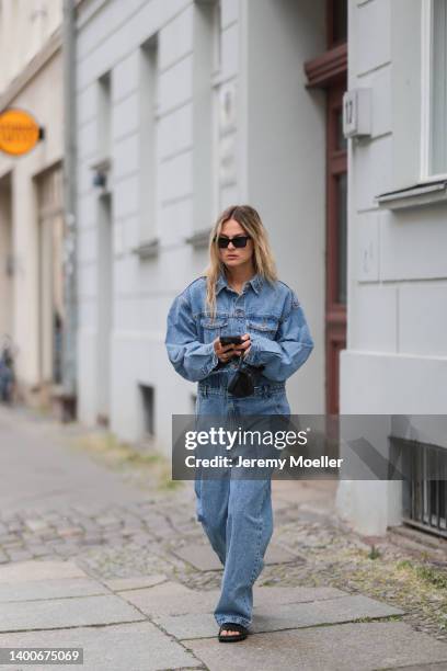 Alessa Winter wearing Chanel black shades, Longchamp black mini bag, The Frankie Shop jeans overall and Inuikii black shoes on May 31, 2022 in...